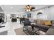 Open concept living room with modern decor, tile floors, comfortable seating, and kitchen view at 3318 Dewberry Dr, Deltona, FL 32738
