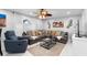Inviting living room featuring a comfortable sofa, stylish decor, and a ceiling fan at 3318 Dewberry Dr, Deltona, FL 32738