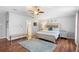 Serene main bedroom with a plush bed, hardwood floors, and a doorway to the ensuite bathroom at 3318 Dewberry Dr, Deltona, FL 32738