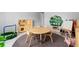 Charming playroom featuring a kitchen set, round table, bookcase shaped like a tree, and a mini trampoline at 3318 Dewberry Dr, Deltona, FL 32738