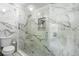 Modern glass enclosed shower featuring marble walls, a rainfall showerhead, and a built-in niche at 3318 Dewberry Dr, Deltona, FL 32738