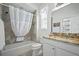 Bathroom with a shower-tub combo, toilet, and granite countertop vanity with framed mirror at 3432 Wise Way, The Villages, FL 32163