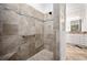 Modern bathroom featuring a tiled shower with grab bar and mosaic accents, plus a large vanity area at 3432 Wise Way, The Villages, FL 32163