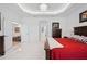 Large bedroom featuring a tray ceiling, chandelier, and multiple entrances to other areas of the house at 3432 Wise Way, The Villages, FL 32163