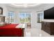 Spacious bedroom featuring tray ceilings, a chandelier, and multiple windows offering bright outdoor views at 3432 Wise Way, The Villages, FL 32163