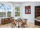 Bright breakfast nook featuring a glass table and modern chandelier with views of the well-maintained lawn at 3432 Wise Way, The Villages, FL 32163