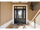 Elegant front door with decorative glass and sidelights, surrounded by a neutral stucco exterior at 3432 Wise Way, The Villages, FL 32163
