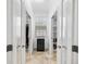 Bright hallway with tile floor, recessed lighting, and wine cooler framed by closet entrances on either side at 3432 Wise Way, The Villages, FL 32163