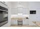 Kitchen area with granite counters, white cabinetry, and stainless steel appliances and chandelier at 3432 Wise Way, The Villages, FL 32163