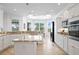 Large kitchen with white cabinets, stainless steel appliances, and an island, perfect for cooking at 3432 Wise Way, The Villages, FL 32163