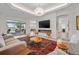 Spacious living room with a sliding door leading to a patio, fireplace, and a chandelier at 3432 Wise Way, The Villages, FL 32163