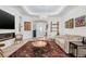 Spacious living room featuring fireplace, decorative rug, and cozy seating at 3432 Wise Way, The Villages, FL 32163