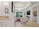 Open-concept living room with a modern fireplace, and view of the pool area at 3432 Wise Way, The Villages, FL 32163