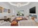 Bright living room showcasing a fireplace, furniture, decor, and sliding glass doors to the backyard at 3432 Wise Way, The Villages, FL 32163