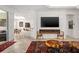 Open-concept living room featuring a bar with seating, a fireplace, and stylish decor at 3432 Wise Way, The Villages, FL 32163