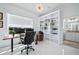 Bright home office with a large window, built-in shelving, and modern desk setup at 3432 Wise Way, The Villages, FL 32163
