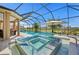 Relaxing screened in pool with a jacuzzi, umbrella, and views of the golf course at 3432 Wise Way, The Villages, FL 32163