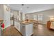 Well-lit kitchen featuring an island with a sink, granite countertops, and stainless steel appliances at 3529 Patron Ave, Deltona, FL 32738