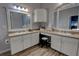 Bright bathroom featuring double sinks with white cabinetry and stylish wood-look tile flooring at 36320 Piney Ridge Blvd, Fruitland Park, FL 34731