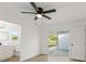 Bedroom with fan, window, and adjacent bathroom, offering serene living at 3813 Long Grove Ln, Port Orange, FL 32129