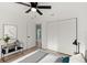 Bright bedroom features a ceiling fan, closet doors, and an open doorway creating an inviting and functional space at 3813 Long Grove Ln, Port Orange, FL 32129
