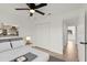 A bright bedroom featuring a ceiling fan, closet doors, and natural light, offers a comfortable and functional space at 3813 Long Grove Ln, Port Orange, FL 32129