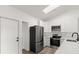 Bright kitchen with stainless steel appliances, white cabinets, and wood flooring at 3813 Long Grove Ln, Port Orange, FL 32129