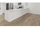 Updated kitchen featuring modern stainless steel appliances, white cabinets and countertops, and wood flooring at 3813 Long Grove Ln, Port Orange, FL 32129