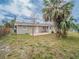 The backyard has a patio, grassy area, and a few trees at 412 Cherry St, South Daytona, FL 32119