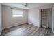Bright bedroom features wood-look floors, closet with louvered doors and a ceiling fan at 412 Cherry St, South Daytona, FL 32119