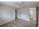 Bedroom with wood-look flooring, ceiling fan, closet with louvered doors, and adjacent bathroom at 412 Cherry St, South Daytona, FL 32119