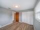 Bedroom with a window, a closet with louvered doors and wood-look flooring at 412 Cherry St, South Daytona, FL 32119