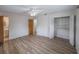 Spacious bedroom with wood-look flooring, ceiling fan, and closet with louvered doors at 412 Cherry St, South Daytona, FL 32119