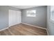 Cozy bedroom featuring wood-look flooring, closet with louvered doors and a window at 412 Cherry St, South Daytona, FL 32119