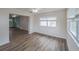 Open-concept bonus room with modern floors and connecting views to other living spaces at 412 Cherry St, South Daytona, FL 32119