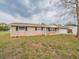 Charming single-story home with tan siding, black shutters, and well-maintained front yard at 412 Cherry St, South Daytona, FL 32119