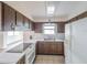 Functional kitchen featuring white appliances, laminate countertops, and wood-look cabinets at 412 Cherry St, South Daytona, FL 32119