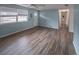 Open-concept living room with modern wood-look flooring and light blue walls at 412 Cherry St, South Daytona, FL 32119