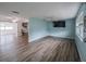 Spacious living room with modern flooring seamlessly connecting to the adjacent kitchen and dining area at 412 Cherry St, South Daytona, FL 32119