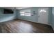 Bright living room featuring modern wood-look flooring, ceiling fan, and a large window at 412 Cherry St, South Daytona, FL 32119