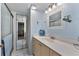 Modern bathroom featuring a shower with glass doors, vanity with generous counter space and a mirror at 4150 S Atlantic Ave # 104 B, New Smyrna Beach, FL 32169