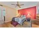 Bedroom featuring a red accent wall, wood floors, comfortable bed, and an adjacent desk area at 4150 S Atlantic Ave # 104 B, New Smyrna Beach, FL 32169