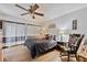 Cozy bedroom with a ceiling fan, comfortable bed, hardwood floors, and soft natural light at 4150 S Atlantic Ave # 104 B, New Smyrna Beach, FL 32169
