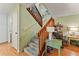 Inviting carpeted staircase with a wooden railing, leading to the upper level of the home at 4150 S Atlantic Ave # 104 B, New Smyrna Beach, FL 32169