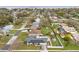 Aerial view of a home with solar panels, a private pool, and a well-maintained lawn at 445 Virginia Ave, St Cloud, FL 34769