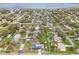 Aerial view of neighborhood with houses, trees, lake in the distance at 445 Virginia Ave, St Cloud, FL 34769
