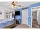 Bedroom with ceiling fan, TV on wall, closet, and view to hallway at 445 Virginia Ave, St Cloud, FL 34769