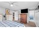 Bedroom featuring a TV, closet, and neutral tones, connecting to an ensuite bathroom at 445 Virginia Ave, St Cloud, FL 34769