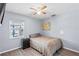 Bedroom with a ceiling fan, neutral walls, wood floors and window bringing in natural light at 445 Virginia Ave, St Cloud, FL 34769