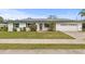 Charming single-story home featuring a well-maintained lawn, solar panels and attached garage at 445 Virginia Ave, St Cloud, FL 34769